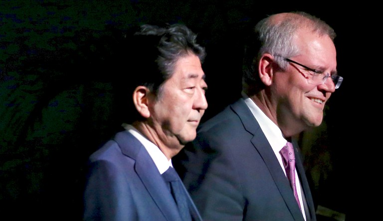 Australian Prime Minister Scott Morrison (right) and Japanese Prime Minister Shinzo Abe (left) arrive at an event in Darwin, Australia, on Friday.