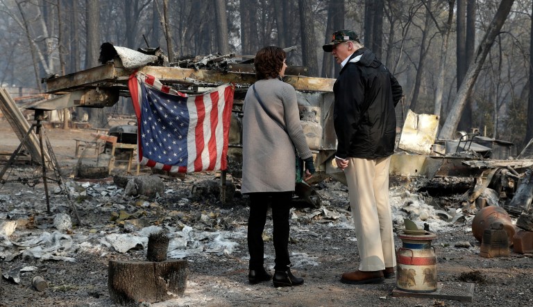 President Trump talks to Mayor Jody Jones as he visits a neighborhood impacted by the wildfires on Saturday in Paradise, Calif. 