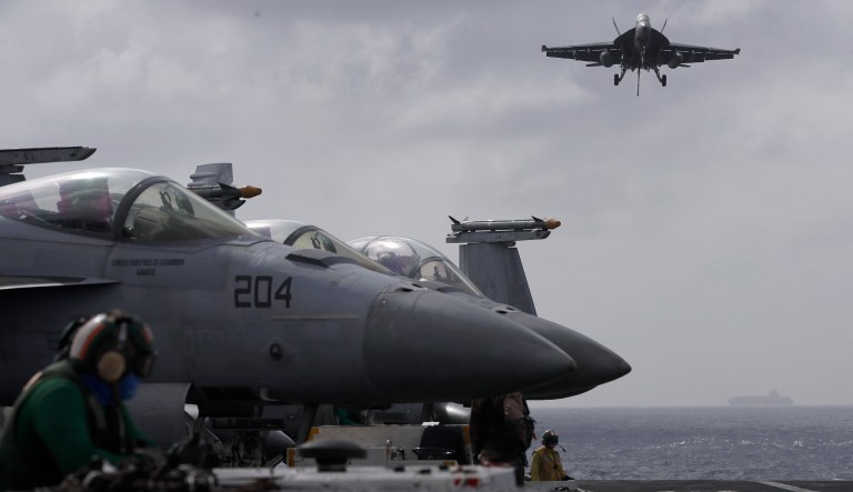 An F/A-18 Super Hornet fighter jet lands on the deck of the U.S. Navy USS Ronald Reagan in the South China Sea, Tuesday, Nov. 20, 2018.
