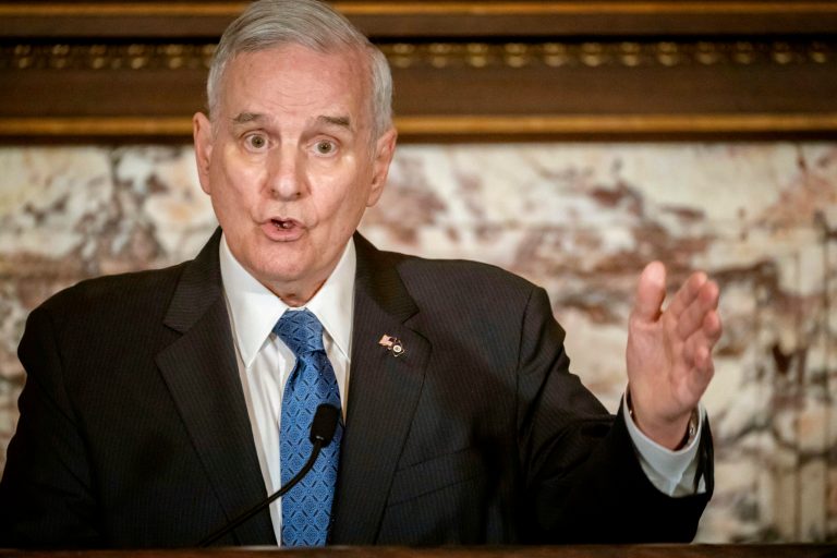 FILE - In this May 23, 2018, file photo, Minnesota Gov. Mark Dayton speaks at a press conference in St. Paul, Minn. Dayton says he expects to be home before Thanksgiving after complications from back surgery required more than a month of hospitalization. Dayton hasn't been seen publicly since before his first surgery on Oct. 12. 