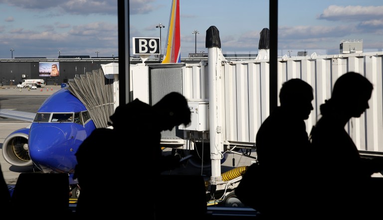Travelers wait in line to board a flight at Baltimore-Washington International Thurgood Marshall Airport, Tuesday, Nov. 20, 2018, in Linthicum, Md.