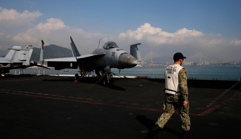 A U.S. Navy sailor walks on the deck of the USS Ronald Reagan aircraft carrier in Hong Kong, Wednesday, Nov. 21, 2018. The USS Reagan docked in Hong Kong days after a pair of American B-52 bombers flew over the disputed South China Sea.