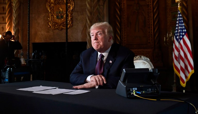President Donald Trump speaks to reporters following his teleconference with troops from his Mar-a-Lago estate in Palm Beach, Fla., Thursday, Nov. 22, 2018.
