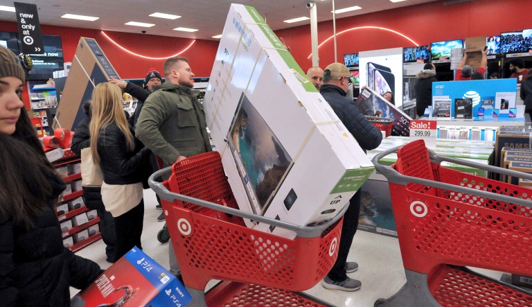 People look at the electronics section on Black Friday at a Target store in Plainville, Mass., Friday, Nov. 23, 2018.