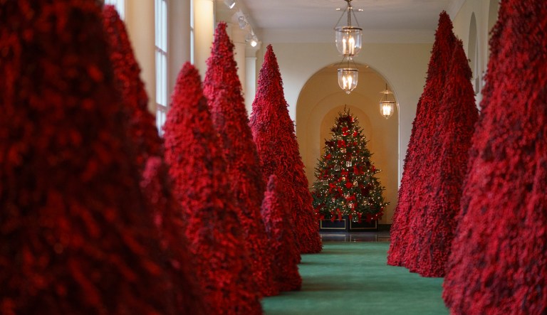 Topiary trees line the eastern colonnade in the White House during the 2018 Christmas Press Preview, Washington, Monday, Nov. 26, 2018.