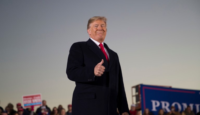 President Trump gives a thumbs-up during a rally for Sen. Cindy Hyde-Smith, R-Miss., at Tupelo Regional Airport, Monday, Nov. 26, 2018, in Tupelo, Miss.