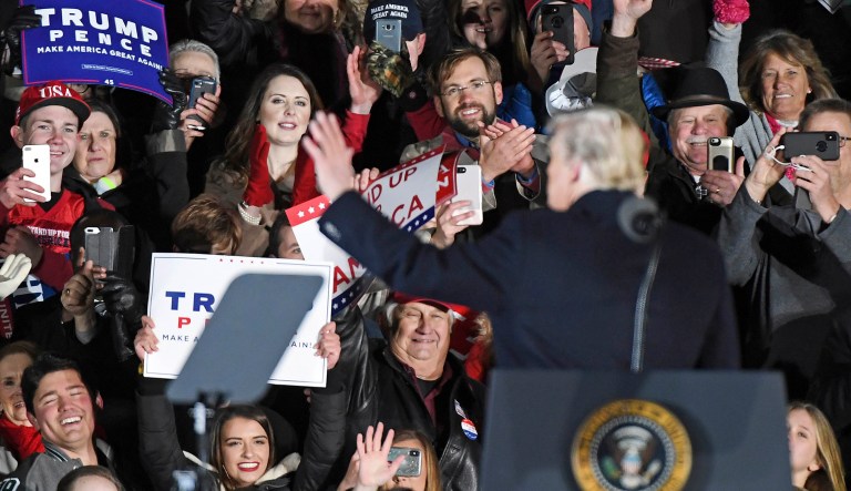President Donald Trump waves to supporters during a rally in Tupelo, Miss., Monday, Nov. 26, 2018, for winning Senate candidate Cindy Hyde-Smith.