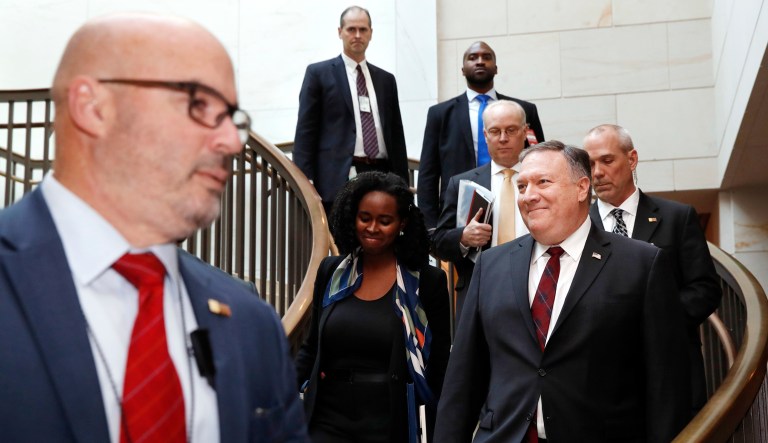 Secretary of State Mike Pompeo, right, arrives for a closed door meeting with senators about Saudi Arabia on Wednesday on Capitol Hill in D.C.