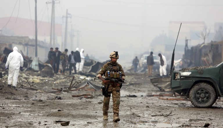 An Afghan security force walks around the site of suicide bomb attack in Kabul, Afghanistan, Thursday, Nov. 29, 2018.