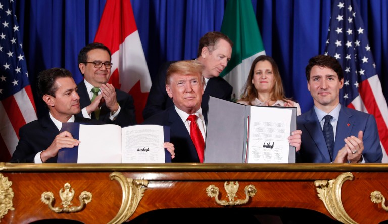 President Trump, Canada's Prime Minister Justin Trudeau, right, and Mexico's President Enrique Pena Nieto, left, participate in the USMCA signing ceremony.