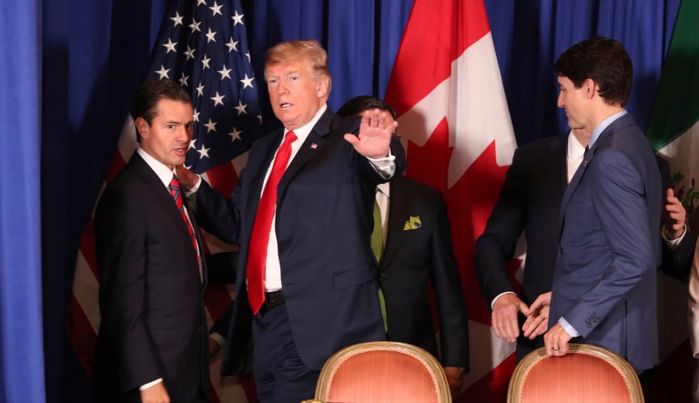 President Trump waves between Mexico's President Enrique Pena Nieto, left, and Canada's Prime Minister Justin Trudeau as they prepare to sign a new United States-Mexico-Canada Agreement that is replacing the NAFTA trade deal, during a ceremony at a hotel before the start of the G-20 summit in Buenos Aires, Argentina, Friday, Nov. 30, 2018.
