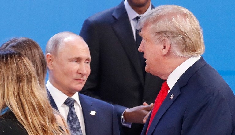 President Trump, right, walk past Russia's President Vladimir Putin, left, as they gather for the group photo at the start of the G-20 summit in Buenos Aires, Argentina.