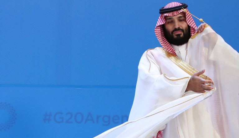 Saudi Arabia's Crown Prince Mohammed bin Salman adjusts his robe as leaders gather for the group at the G20 Leader's Summit at the Costa Salguero Center in Buenos Aires, Argentina, Friday, Nov. 30, 2018. The prince is a controversial figure at the summit, due to the killing of a dissident Saudi journalist in the country's Istanbul consulate. Saudi Arabia denies that bin Salman ordered the killing, but U.S. intelligence agencies have concluded the opposite.