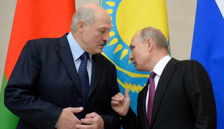 Russian President Vladimir Putin, right, and Belarus' President Alexander Lukashenko talk to each other at the Eurasian Economic Council in St. Petersburg, Russia, Thursday, Dec. 6, 2018.