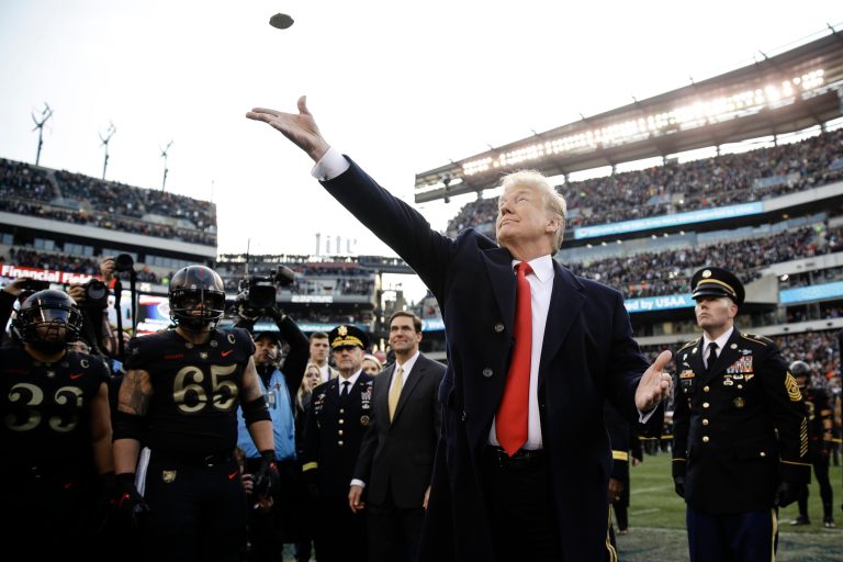 President Donald Trump tosses the coin before the Army-Navy NCAA college football Saturday, Dec. 8, 2018, in Philadelphia.