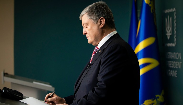 Ukraine President Petro Poroshenko signs a law approved by the Parliament on the termination of the Treaty on Friendship, Cooperation and Partnership between Ukraine and the Russian Federation in Kiev, Ukraine, Monday, Dec. 10, 2018.