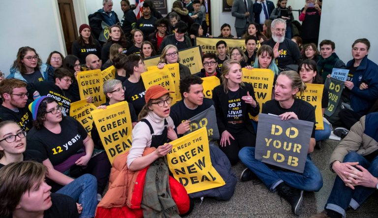Environmental activists occupy the office of Rep. Steny Hoyer, D-Md., the incoming majority leader, as they try to pressure Democratic support for a sweeping agenda to fight climate change, on Capitol Hill in Washington, Monday, Dec. 10, 2018. 