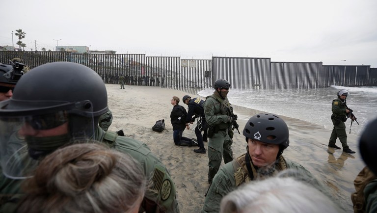 Immigrant rights activists are arrested by border patrol agents during a protest at the border wall.