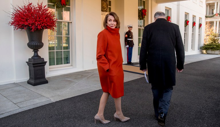 House Minority Leader Nancy Pelosi of Calif., left, speaks to a reporter as she and Senate Minority Leader Sen. Chuck Schumer of N.Y., right, walk back into the West Wing after speaking to members of the media outside of the White House in Washington, Tuesday, Dec. 11, 2018, following a meeting with President Donald Trump. 