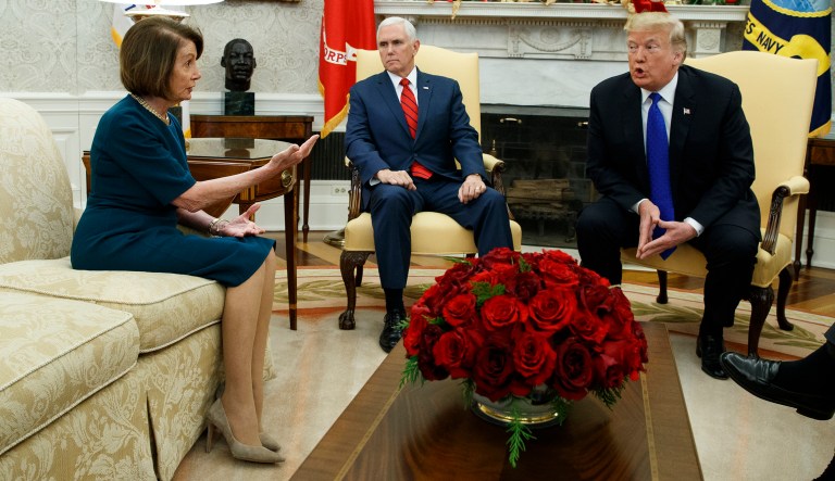 Vice President Mike Pence, center, looks on as House Minority Leader Rep. Nancy Pelosi, D-Calif., and President Donald Trump argue during a meeting in the Oval Office of the White House, Tuesday, Dec. 11, 2018, in Washington.