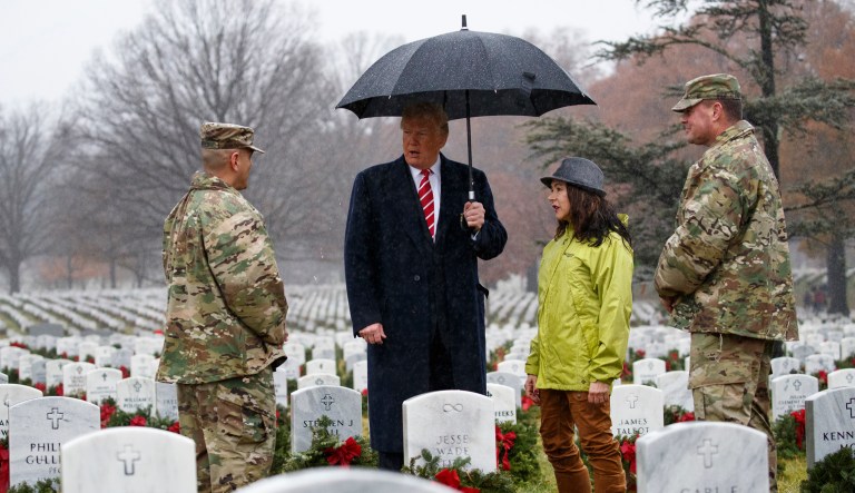 President Trump pauses and talks as he visits Section 60 at Arlington National Cemetery in Arlington, Va., on Saturday during Wreaths Across America Day.