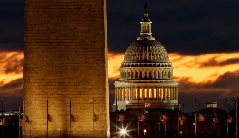 The U.S. Capitol dome is seen past the base of the Washington Monument in D.C.