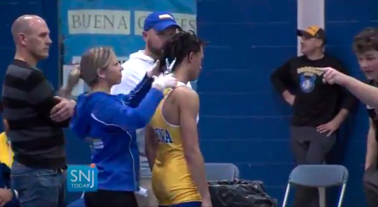 FILE - In this file image taken from a Wednesday, Dec. 19, 2018, video provided by SNJTODAY.COM, Buena Regional High School wrestler Andrew Johnson gets his hair cut courtside minutes before his match in Buena, N.J., after a referee told Johnson he would forfeit his bout if he did not have his dreadlocks cut off.