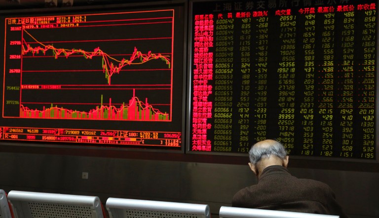 A Chinese man naps at a brokerage in Beijing, China, Tuesday, Dec. 25, 2018. 
