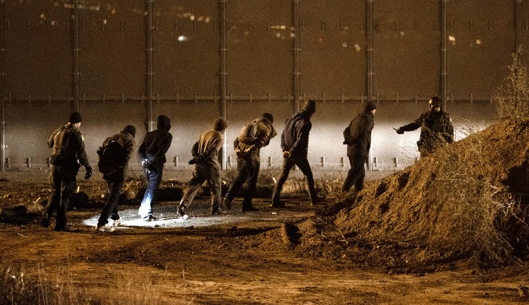 Border patrol officers arrest Honduran migrants after jumping the U.S. border fence into San Diego from Tijuana, Mexico, Tuesday, Dec. 25, 2018. Discouraged by the long wait to apply for asylum through official ports of entry, many Central American migrants from recent caravans are choosing to cross the U.S. border wall and hand themselves in to border patrol agents.