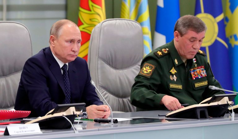 Russian President Vladimir Putin, left, and Chief of General Staff of Russia Valery Gerasimov oversee the test launch of the Avangard hypersonic glide vehicle from the Defense Ministry's control room in Moscow, Russia, Wednesday, Dec. 26, 2018. In the test, the Avangard was launched from the Dombarovskiy missile base in the southern Ural Mountains. The Kremlin says it successfully hit a designated practice target on the Kura shooting range on Kamchatka, 6,000 kilometers (3,700 miles) away.
