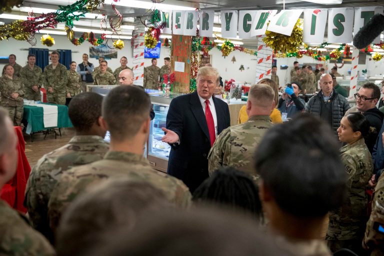 President Donald Trump visits with members of the military at a dining hall at Al Asad Air Base, Iraq, Wednesday, Dec. 26, 2018. In a surprise trip to Iraq, President Donald Trump on Wednesday defended his decision to withdraw U.S. forces from Syria where they have been helping battle Islamic State militants.