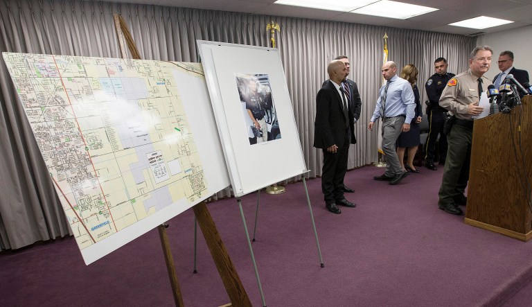 Kern County Sheriff Donny Youngblood, right, speaks at a news conference in Bakersfield, Calif., after suspect Gustavo Perez Arriaga surrendered and was taken into custody in Lamont, Calif.