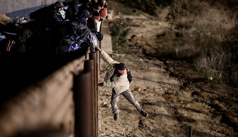 A migrant jumps the border fence to get into the U.S. side to San Diego, Calif., from Tijuana, Mexico, Tuesday, Jan. 1, 2019. Discouraged by the long wait to apply for asylum through official ports of entry, many migrants from recent caravans are choosing to cross the U.S. border wall and hand themselves in to border patrol agents.