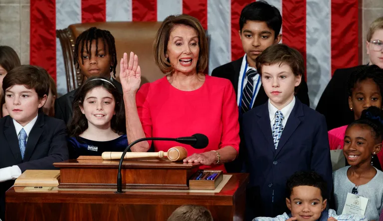 Nancy Pelosi of California, surrounded by her grandchildren raises her right hand as Rep. Don Young, R-Alaska, the longest-serving member of the House, administers the oath to Pelosi to become the Speaker of the House at the Capitol in Washington, Thursday, Jan. 3, 2019.