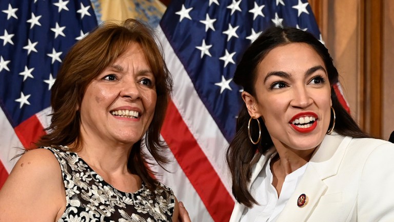 Rep. Alexandria Ocasio-Cortez, D-N.Y., second from left, and her mother Blanca Ocasio-Cortez, left, react during a ceremonial swearing-in.