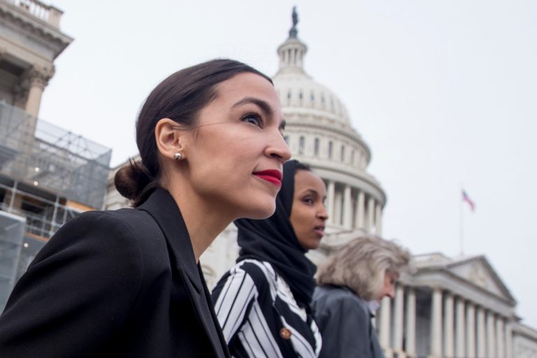 Rep. Alexandria Ocasio-Cortez, D-N.Y., and Rep. Ilhan Omar, D-Minn., walk down the House steps on Capitol Hill in Washington, Friday, Jan. 4, 2019.