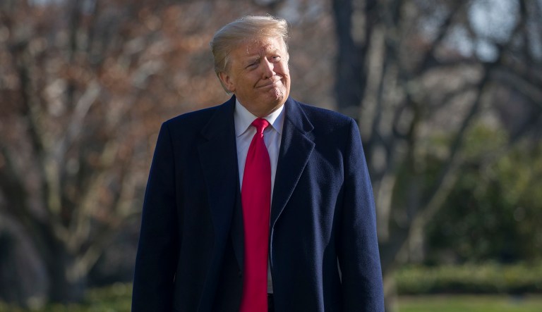 President Trump smiles as he walks on the South Lawn of the White House after stepping off Marine One, Sunday, Jan. 6, 2019, in Washington.