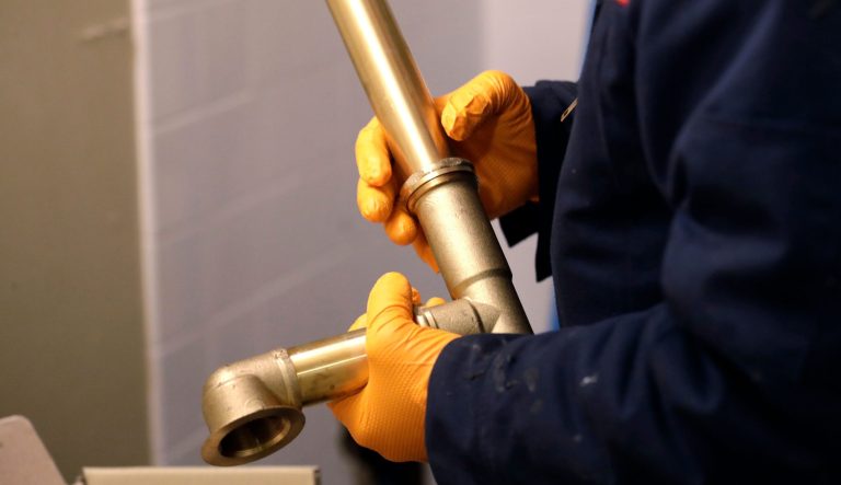In this Dec. 13, 2018, photo a plumber prepares tub drains during a replacement of plumbing in an older apartment building in Seattle. 