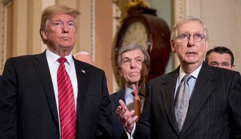 Senate Majority Leader Mitch McConnell of Ky., third from right, accompanied by from left, Sen. John Barrasso, R-Wyo., Sen. John Thune, R-S.D., President Trump, Vice President Mike Pence, Sen. Roy Blunt, R-Mo., Sen. Todd Young, R-Ind., and Sen. Joni Ernst, R-Iowa, speaks to reporters following a Senate Republican Policy lunch on Capitol Hill in Washington, D.C.