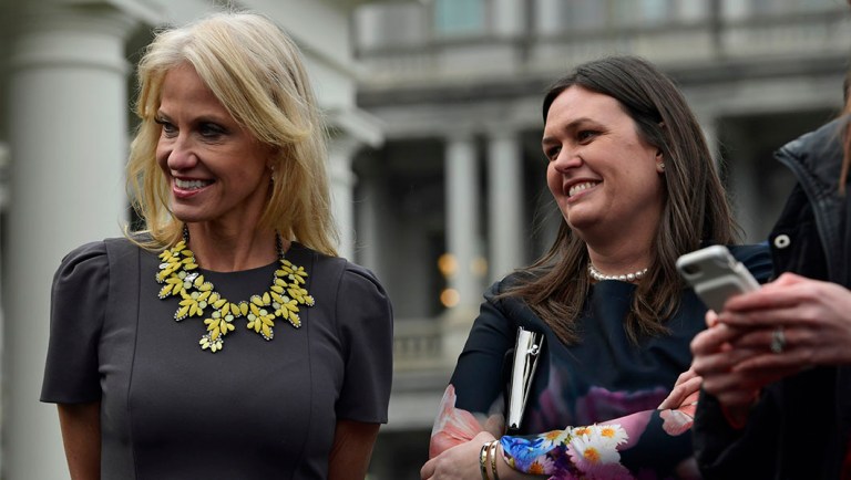 White House counselor Kellyanne Conway, left, and White House press secretary Sarah Huckabee Sanders, right, listen.