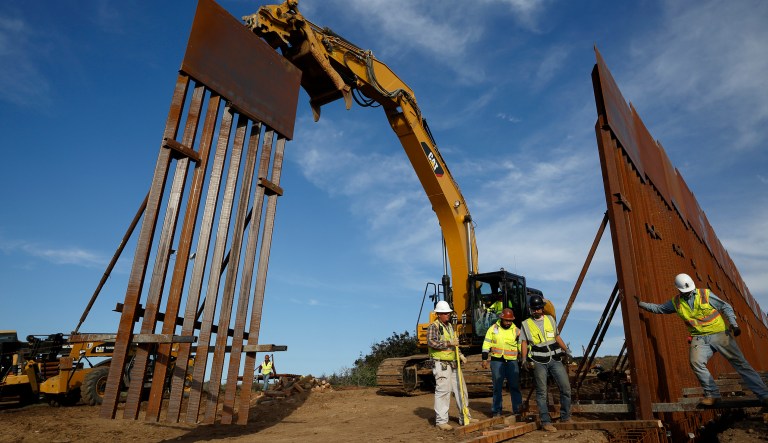 Construction crews install new border wall sections Wednesday, Jan. 9, 2019, seen from Tijuana, Mexico.