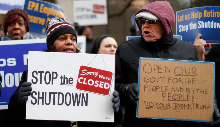 People rally to call for an end to the partial government shutdown on Thursday.