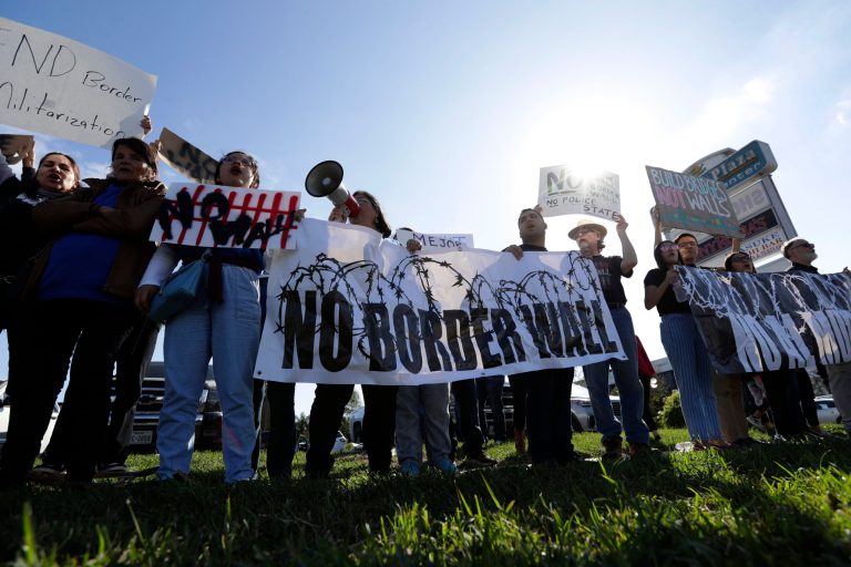 Groups opposed to border walls being built along the Texas-Mexico border gather outside the McAllen International Airport as they wait for the arrival of President Donald Trump who is making a visit to the southern border, Thursday, Jan. 10, 2019, in McAllen, Texas.