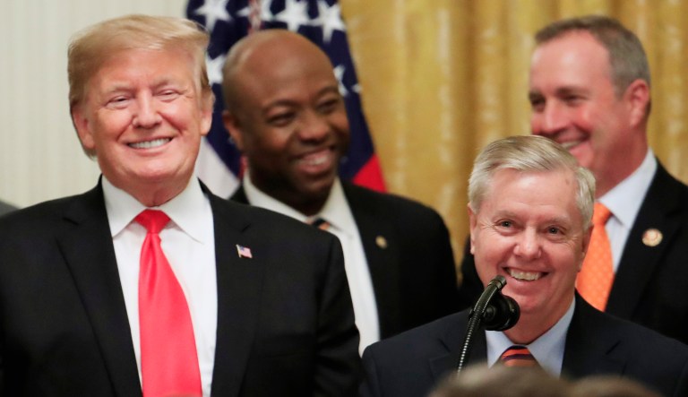 Sen. Lindsey Graham, R-S.C., front right, together with, from left, Clemson head coach Dabo Swinney, President Donald Trump and Sen. Tim Scott, R-S.C., speaks during an event in D.C.