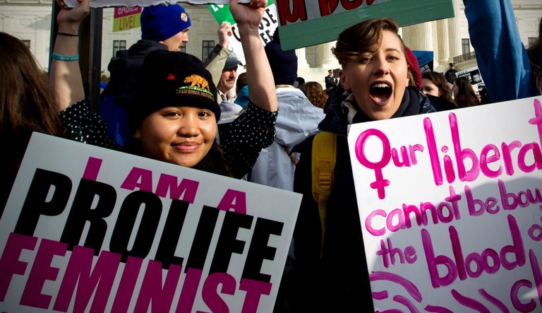 Anti-abortion activists in favor of feminism protest outside of the Supreme Court during the March for Life in Washington.