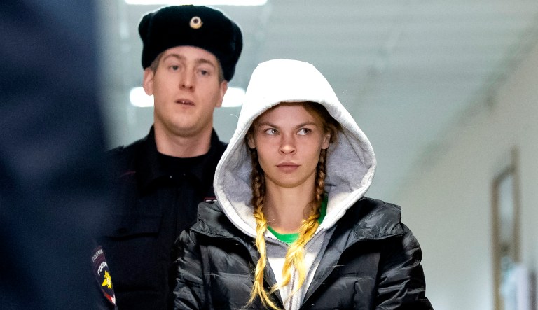 Anastasia Vashukevich, also known on social media as Nastya Rybka, center, is escorted in the court room in Moscow, Russia.