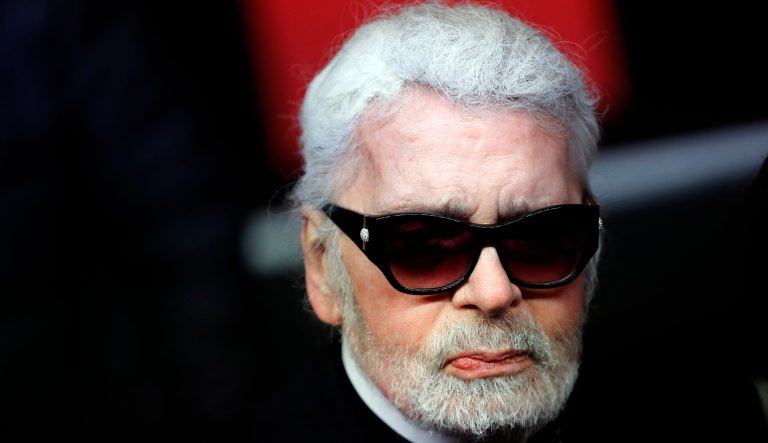 In this Thursday, Nov. 22, 2018 photo, Fashion designer Karl Lagerfeld poses during the Champs Elysee Avenue illumination ceremony for the Christmas season, in Paris. 