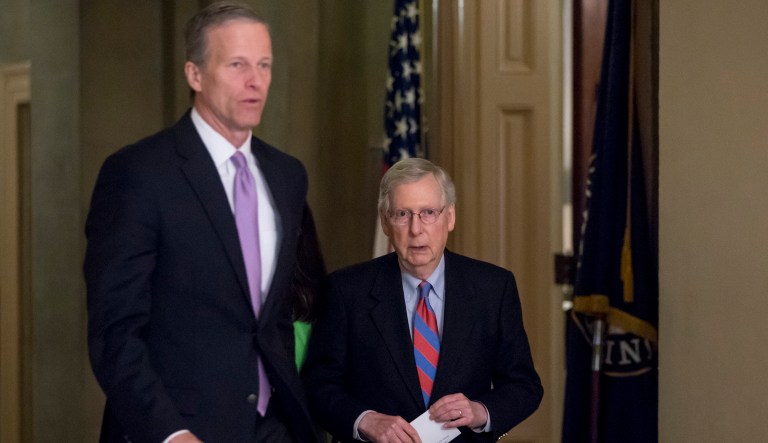 Sen. John Thune, R-S.D., left, and Senate Majority Leader Mitch McConnell of Ky., right, walks into a closed door meeting with Senate Republicans on Capitol Hill in Washington, Friday, Jan. 25, 2019.