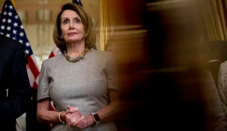 House Speaker Nancy Pelosi, D-Calif., accompanied by House Democratic members, listens to a reporter's question after signing a deal to reopen the government on Capitol Hill in Washington, Friday, Jan. 25, 2019. 