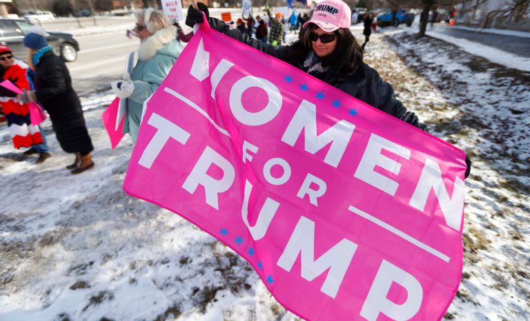 Supporters hold signs at a women for Trump rally in Bloomfield Hills, Mich., Saturday, Jan. 26, 2019. 